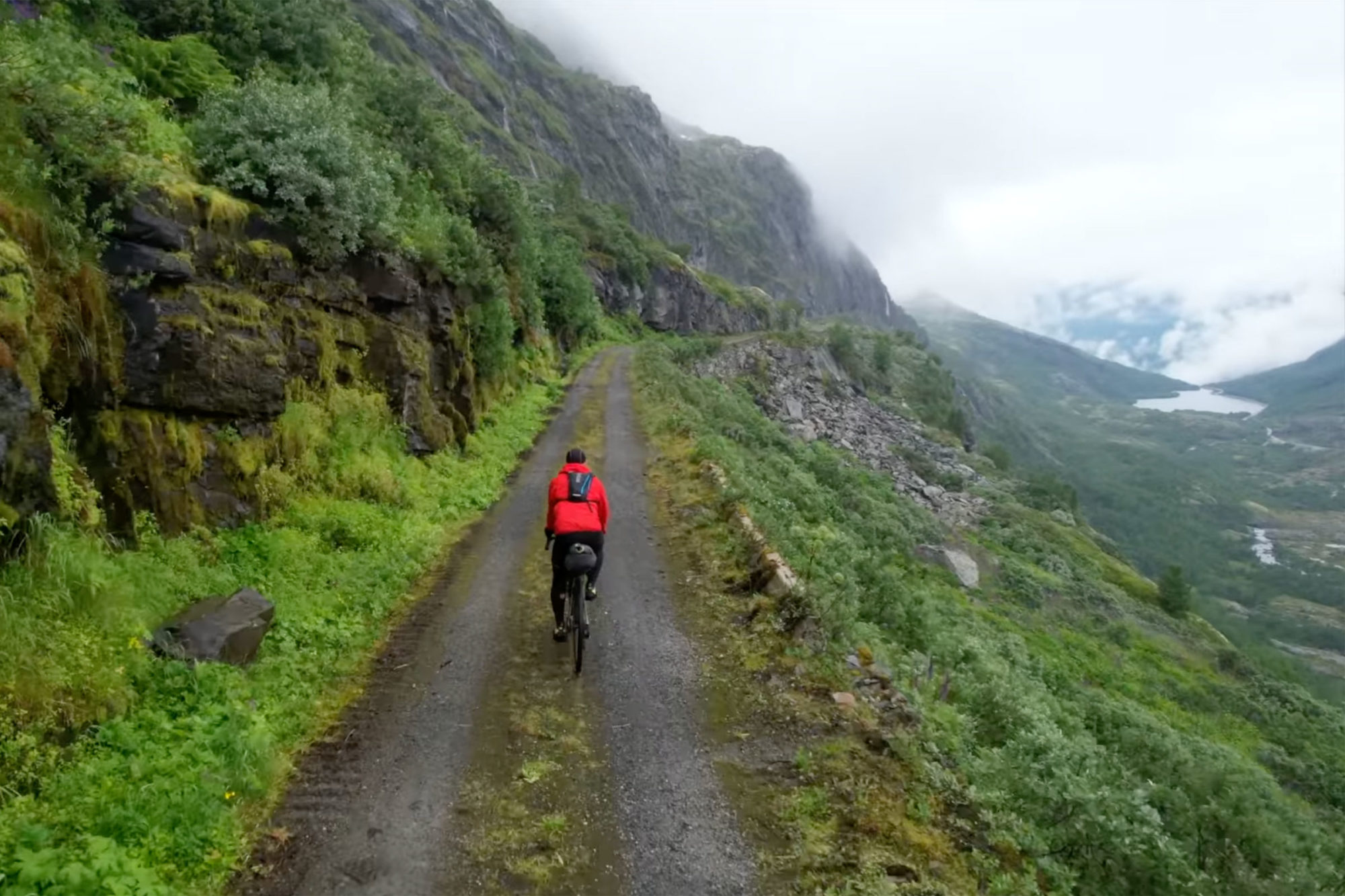 Cyclist on gravel hill road, Norway